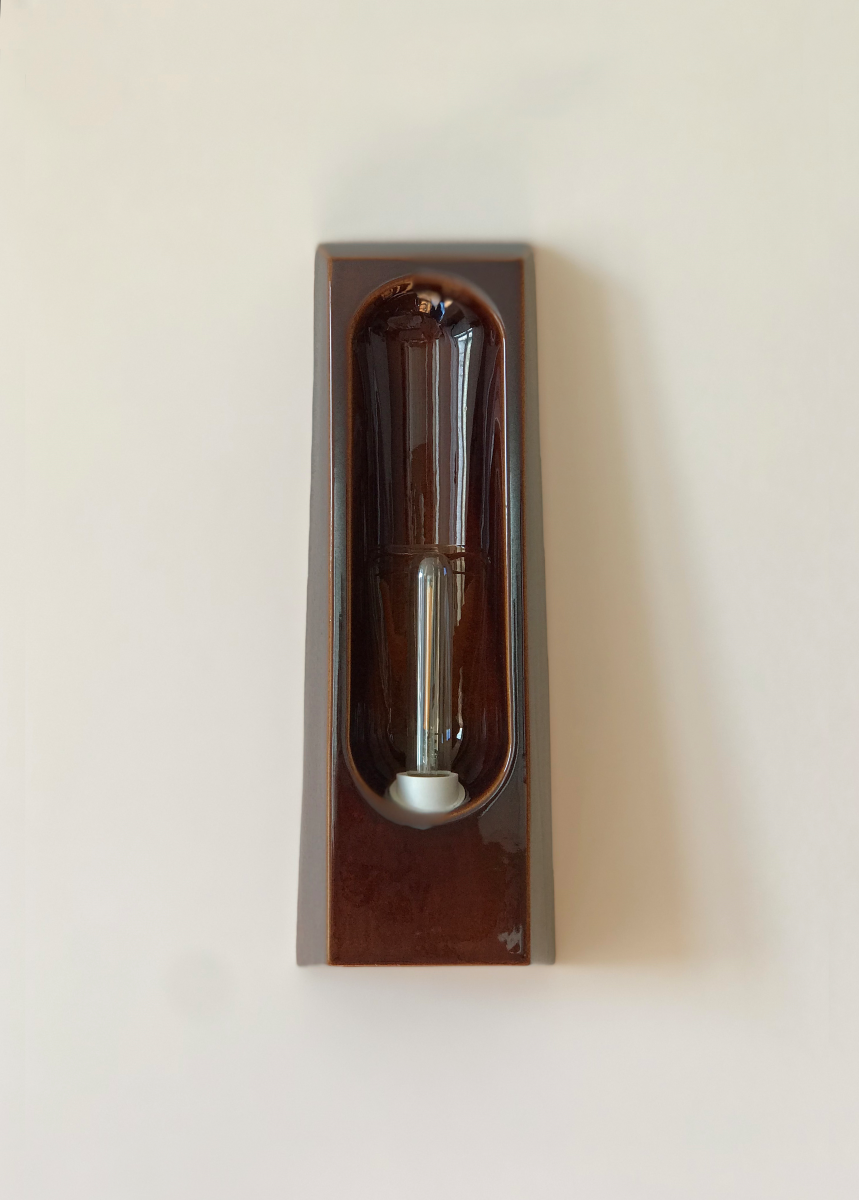 Wall sconce Alcove by Violaine d'Harcourt, in glazed ceramic hand-formed in Portugal. An enveloping silhouette inspired by the architectural alcove, diffusing softened, intimate light.