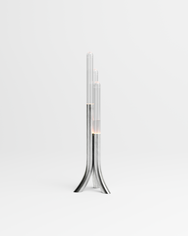 La rencontre de Mickaël avec un artisan verrier lui permet de retranscrire toutes les nuances d'oscillations et de reflets auxquels le paysage méditerranéen l'a habitué. Des cannes striées, fumées ou transparentes assemblées sous la forme d'un cactus élancé et raffiné, qui révèlent toute leur singularité en s'éclairant.  Tous les reliefs du verre sont projetés sur l'environnement qui l'entoure. Une ode au territoire d'origine de Mickaël.