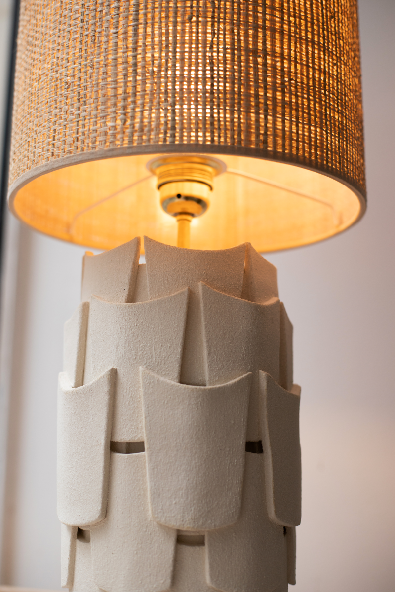 Table lamp Sève by Adeline Delesalle in chamotte stoneware. Stylized leaf-inspired insets, raffia lampshade. Caroline Andréoni Exclusive.