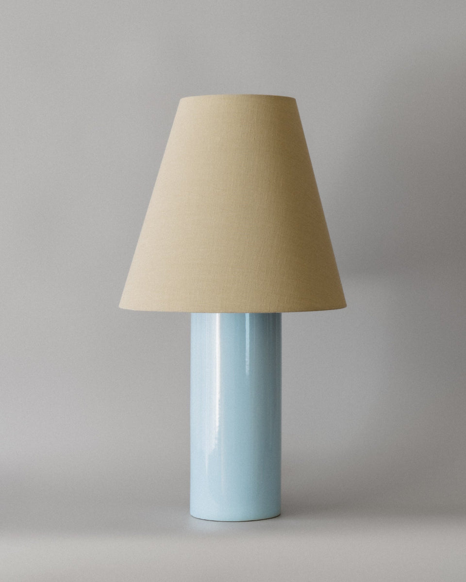 The Giro Baby Blue table lamp, imagined in 3D by Mattina Moderna, a mother-daughter duo from the south of France. Baby blue earthenware base and Haider Ackermann cotton lampshade, between cottage charm and elegance.
