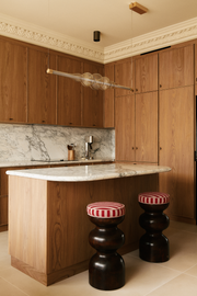 L'alliance de la forme ronde et symétrique, mêlée au motif extrêmement naturel et aléatoire du bois rend chaque création de Romie Objetti unique. Sa finition à la cire d'abeille apporte un rendu satiné et soyeux qui permet de préserver l'aspect naturel et authentique du bois, tout en le sublimant.

Proposée en exclusivité par Caroline Andréoni La Maison, le tabouret Yoko est revêtu par le tissu Voulez-vous teinte Amerana de chez Dedar.