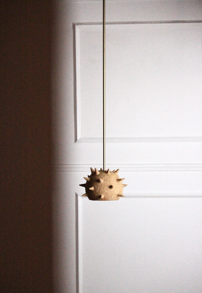 Cette suspension Jupiter constituée de grès chamotte présente une texture avec des grains de sable. La tige et le pavillon sont faits de laiton brossé. Chaque pièce est unique, numérotée, signée et modelée manuellement dans un grès chamotte, une argile cuite plusieurs fois entre 900 et 1400 degrés.

Grâce à la céramique, Alan Louis capture l’essence particulière de l’élégance brute et naturelle.