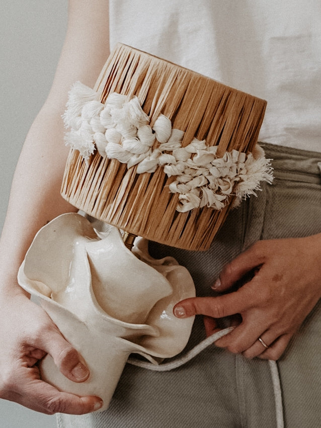 Pour cette lampe, Julie Robert s’est laissé inspirer par les champs de fleurs — surtout des pivoines — qui s’épanouissent chaque printemps sur les hauteurs dominant sa maison du sud de la France. Chaque année, elle observe patiemment la naissance des feuillages, leur croissance silencieuse jusqu’aux dernières récoltes. De cette contemplation rituelle est née l’envie de capturer la grâce éphémère de l’éclosion, de figer dans la lumière les formes mouvantes des pétales.