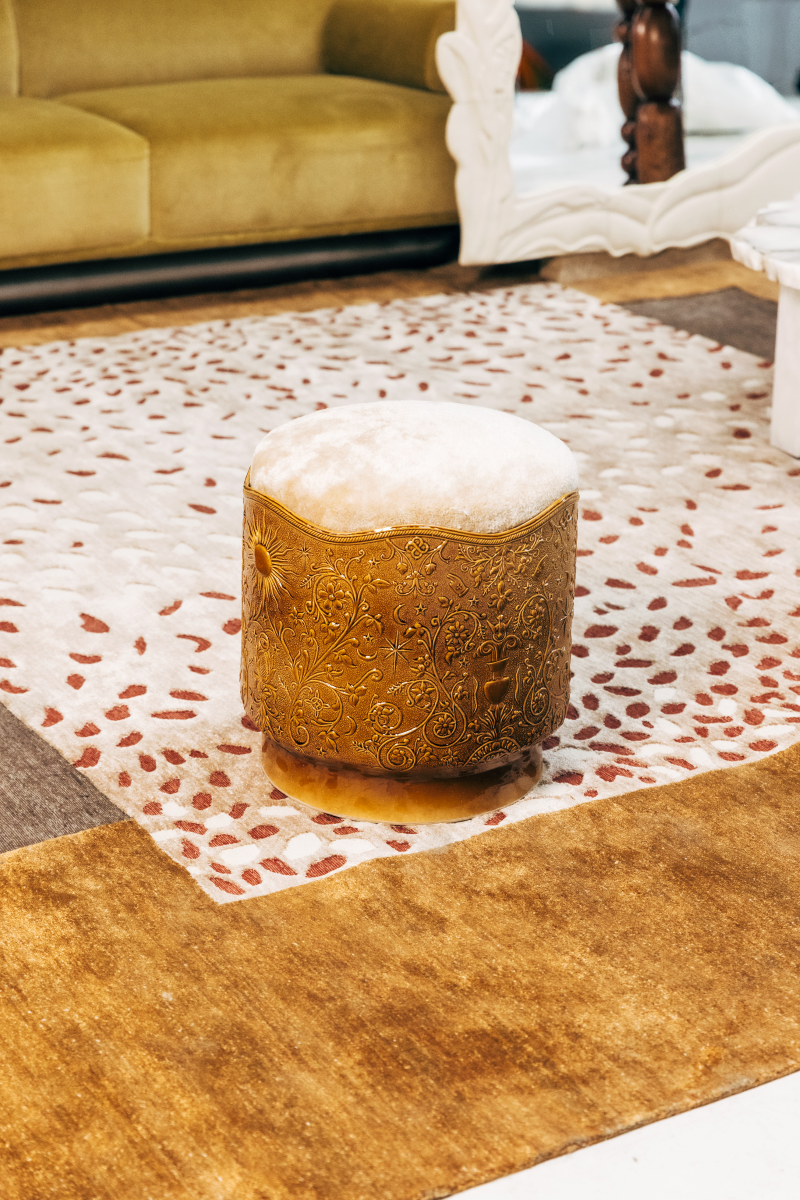 Stool Visconti by Ombre d'Or, in glazed earthenware with a Dedar fabric cushion. Its shaft engraved with alchemical frescoes draws from the Visconti-Sforza Tarot and the heritage of Cordovan leather.